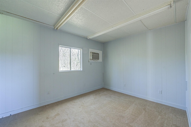 carpeted empty room featuring a wall mounted AC