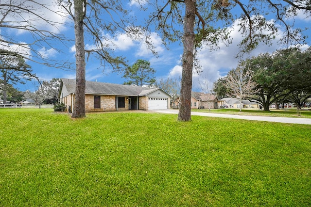 single story home featuring brick siding, a front yard, fence, a garage, and driveway