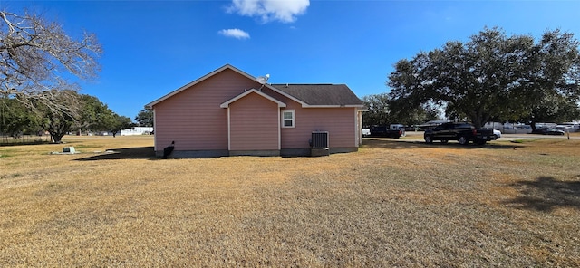 view of home's exterior featuring central AC and a yard