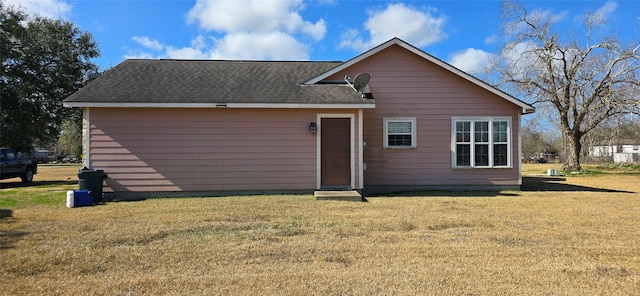 rear view of property with a yard