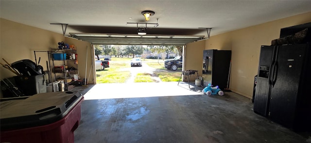 garage featuring a garage door opener and black fridge