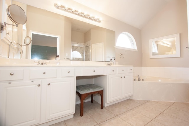 bathroom with tile patterned flooring, vanity, vaulted ceiling, and independent shower and bath