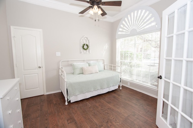 bedroom featuring ornamental molding, dark wood-type flooring, and ceiling fan