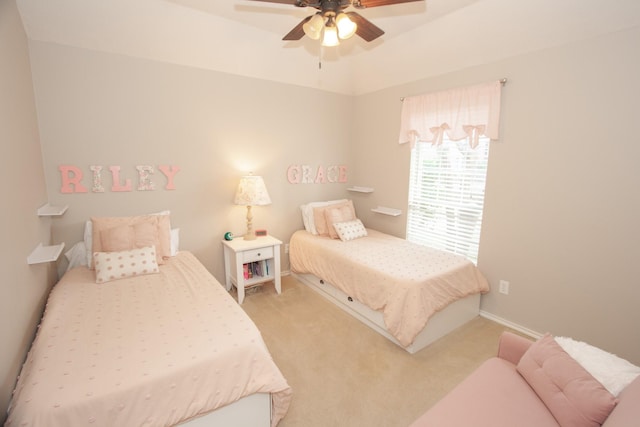 bedroom with ceiling fan and light carpet