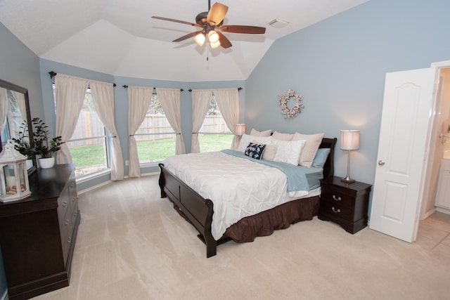 bedroom featuring ceiling fan, light colored carpet, and vaulted ceiling