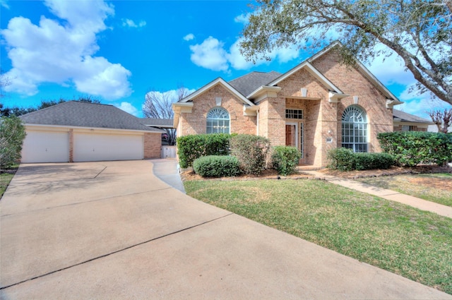 view of property with a garage and a front yard