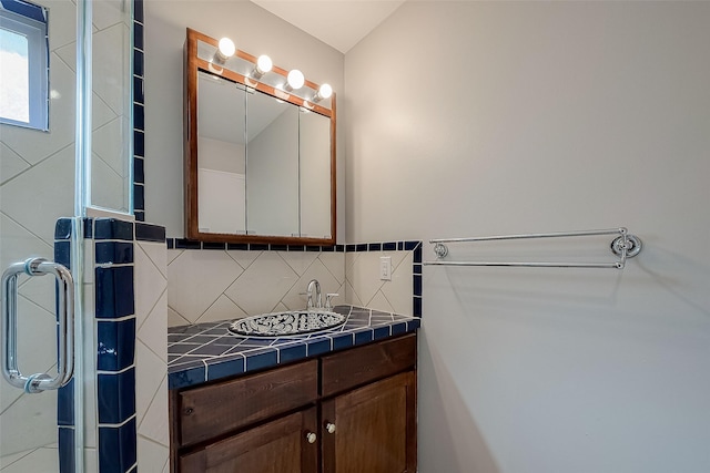 bathroom featuring tasteful backsplash and vanity