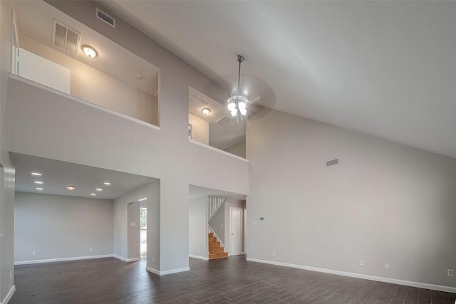 unfurnished living room with dark hardwood / wood-style flooring, high vaulted ceiling, and ceiling fan