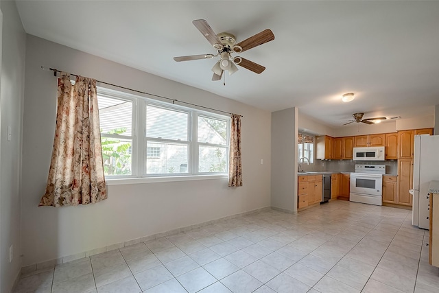 kitchen with sink, white appliances, ceiling fan, and light tile patterned flooring