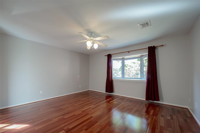 spare room featuring wood-type flooring and ceiling fan