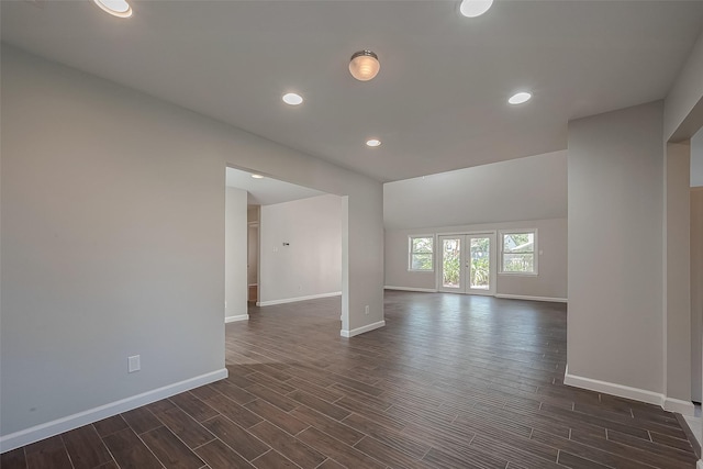 spare room featuring french doors and dark hardwood / wood-style floors