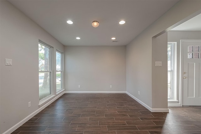 unfurnished room featuring dark wood-type flooring