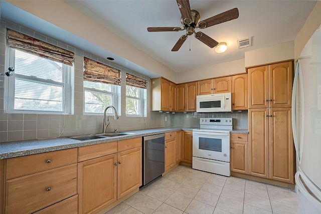 kitchen with light tile patterned flooring, sink, ceiling fan, white appliances, and decorative backsplash