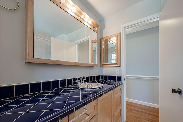 bathroom with vanity and hardwood / wood-style floors