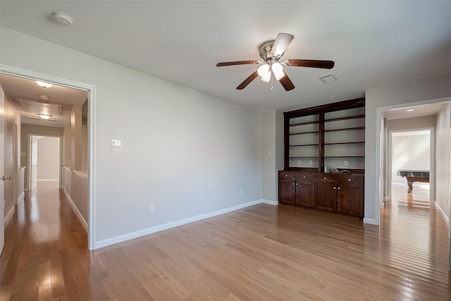 spare room with ceiling fan and light wood-type flooring