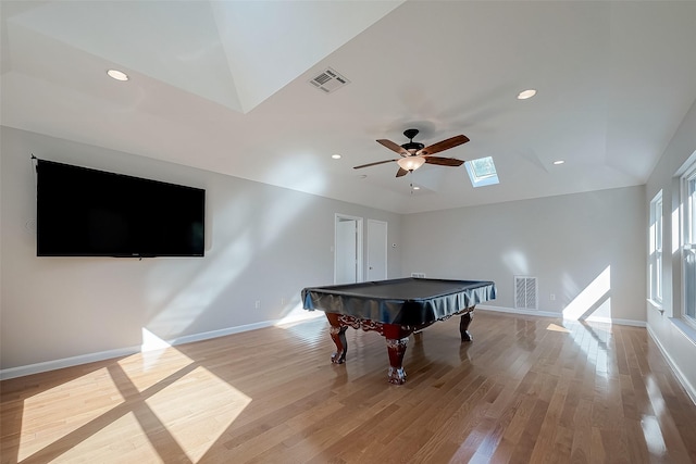 playroom with ceiling fan, pool table, light hardwood / wood-style floors, and vaulted ceiling with skylight