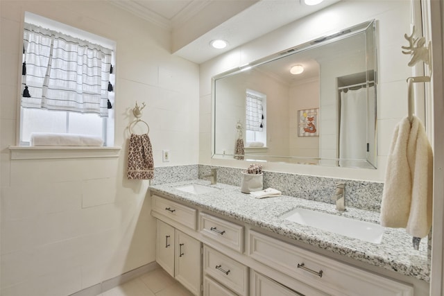 bathroom with walk in shower, ornamental molding, tile patterned flooring, and vanity