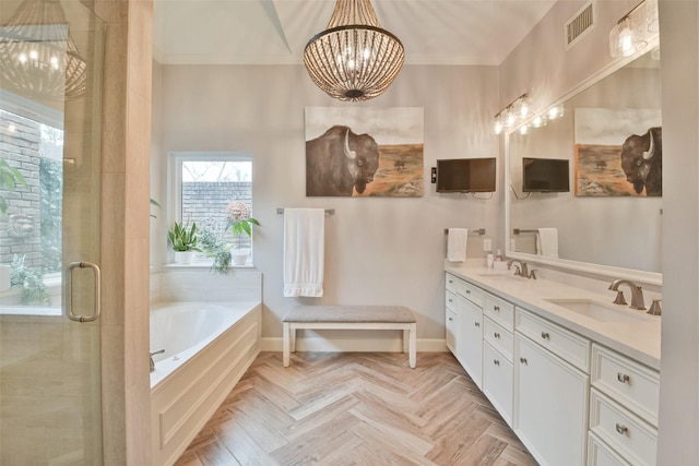 bathroom featuring parquet flooring, shower with separate bathtub, ornamental molding, vanity, and a notable chandelier