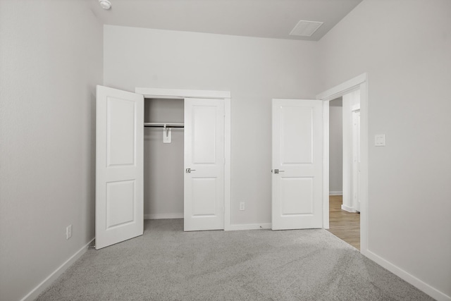 unfurnished bedroom featuring carpet floors and a closet