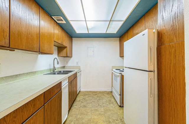 kitchen featuring white appliances and sink