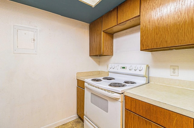 kitchen featuring light tile patterned floors, electric range, and electric panel