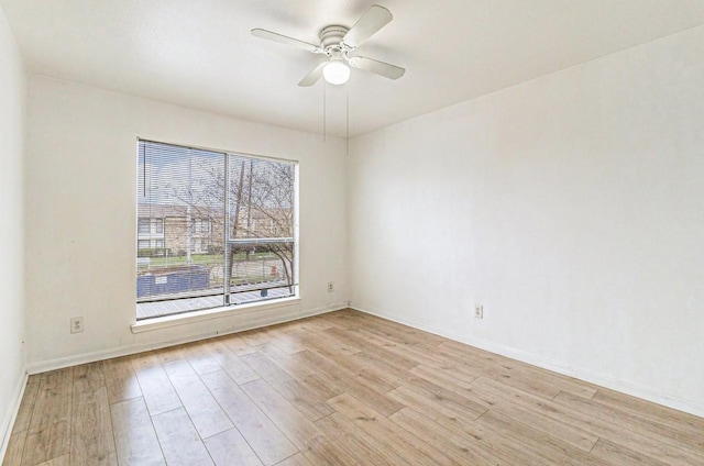 empty room featuring ceiling fan and light wood-type flooring