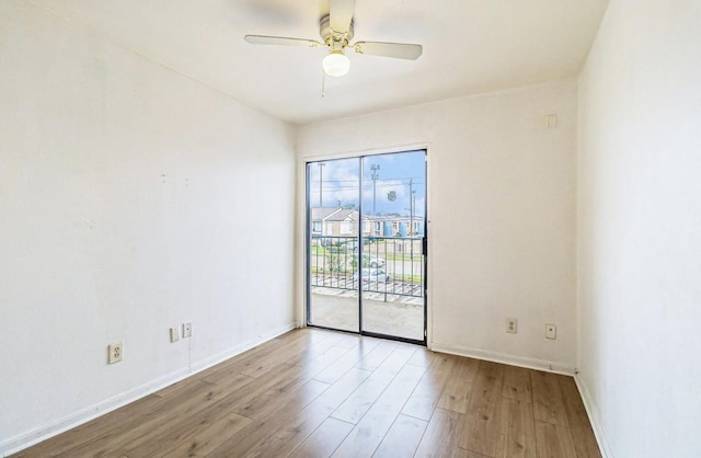 spare room with ceiling fan and light wood-type flooring