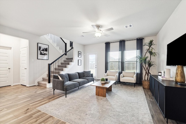 living room with hardwood / wood-style flooring and ceiling fan