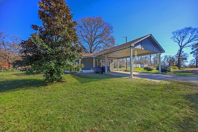 224 Sweetgum St, Trinity, TX 75862 - view of green lawn with a carport and driveway