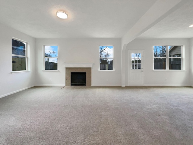 unfurnished living room with light carpet and a high end fireplace