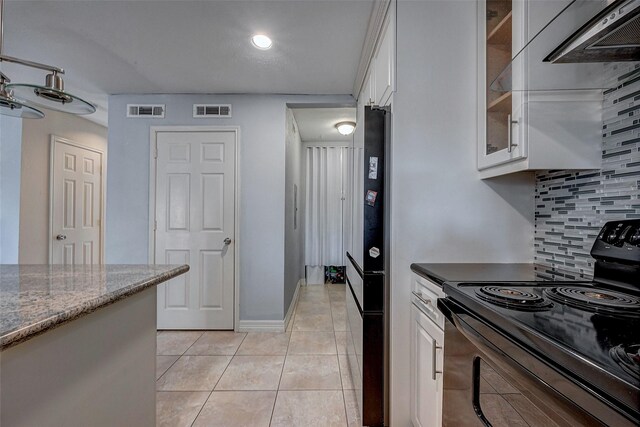 kitchen with white cabinetry, electric range, visible vents, and light tile patterned flooring