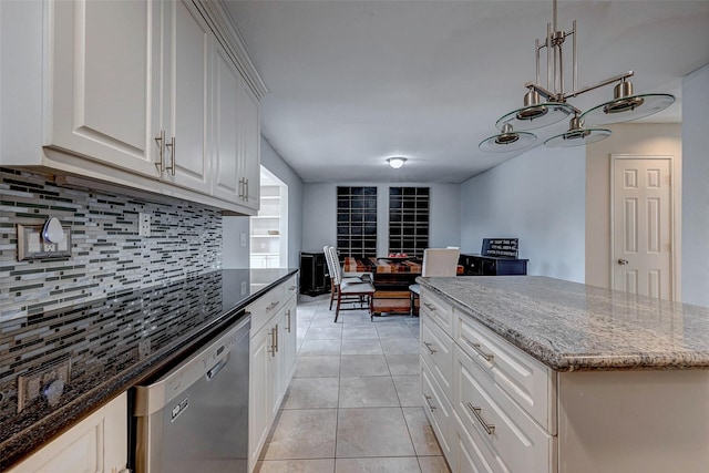 kitchen featuring light tile patterned floors, dark stone counters, decorative backsplash, and dishwasher