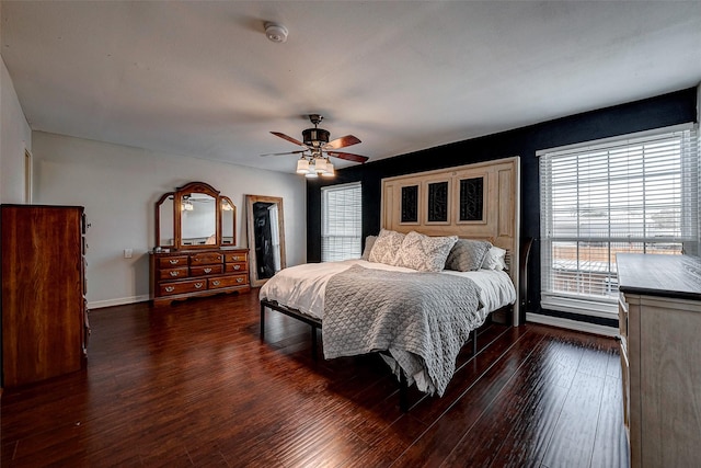 bedroom with dark wood-style floors, ceiling fan, and baseboards