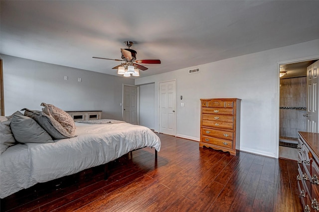 bedroom with dark wood-style floors, visible vents, baseboards, and a ceiling fan