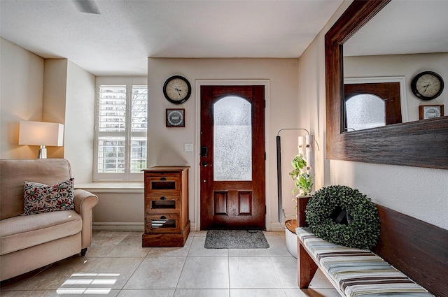 entryway featuring light tile patterned floors and baseboards