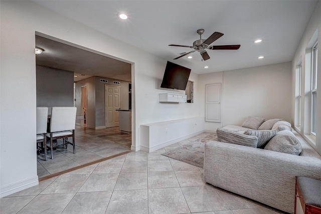 living room with baseboards, light tile patterned floors, a ceiling fan, and recessed lighting