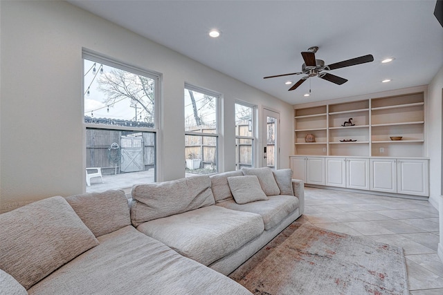 living area featuring light tile patterned flooring, built in features, a ceiling fan, and recessed lighting