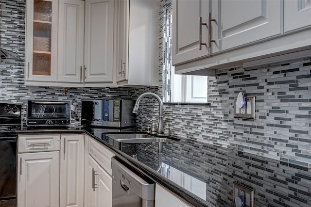 kitchen with a sink, white cabinetry, range, dishwasher, and glass insert cabinets