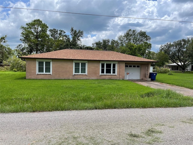 single story home featuring a garage and a front yard