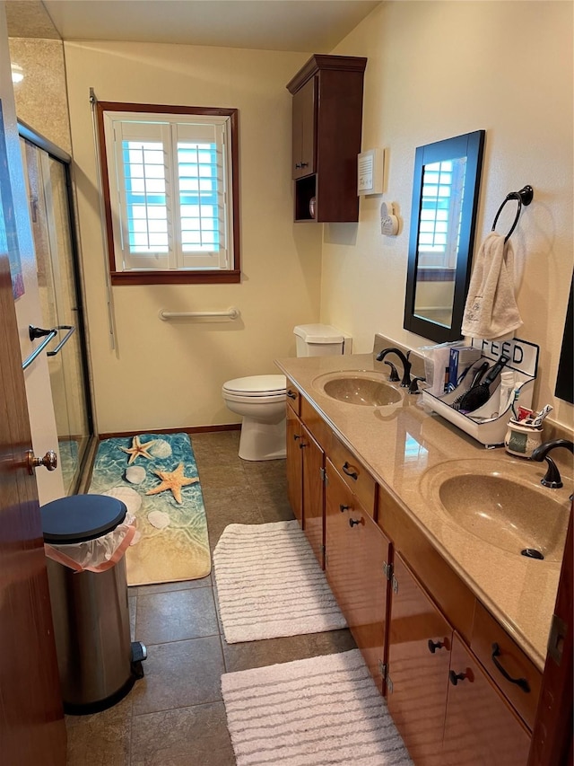 bathroom featuring vanity, a wealth of natural light, an enclosed shower, and toilet