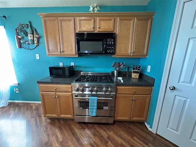 kitchen with dark wood-type flooring and high end range