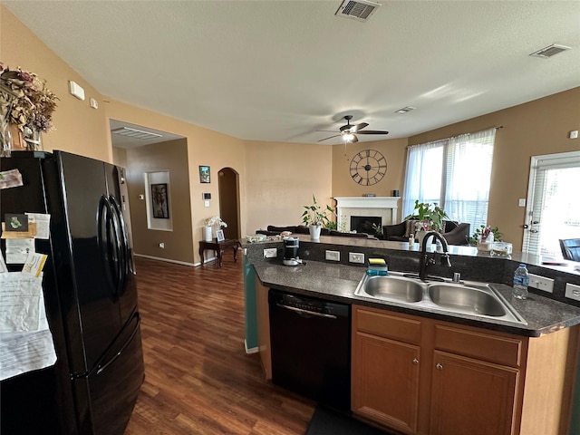 kitchen with ceiling fan, dark hardwood / wood-style flooring, sink, and black appliances