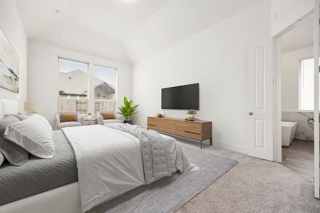 bedroom with lofted ceiling and light carpet