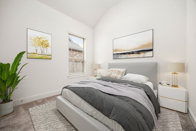 carpeted bedroom with lofted ceiling