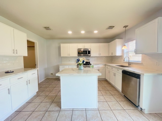 kitchen featuring white cabinetry, stainless steel appliances, and a sink