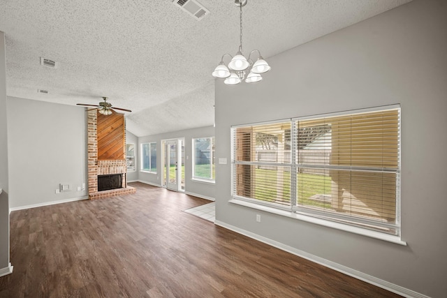 unfurnished living room featuring baseboards, visible vents, lofted ceiling, wood finished floors, and a fireplace