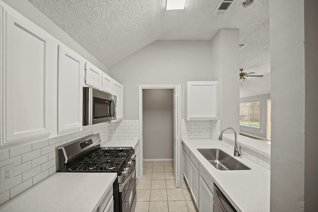 kitchen with visible vents, white cabinets, appliances with stainless steel finishes, light countertops, and a sink