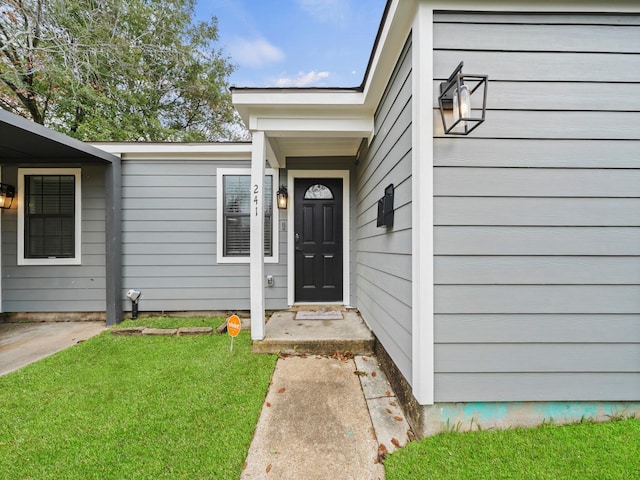 doorway to property featuring a yard