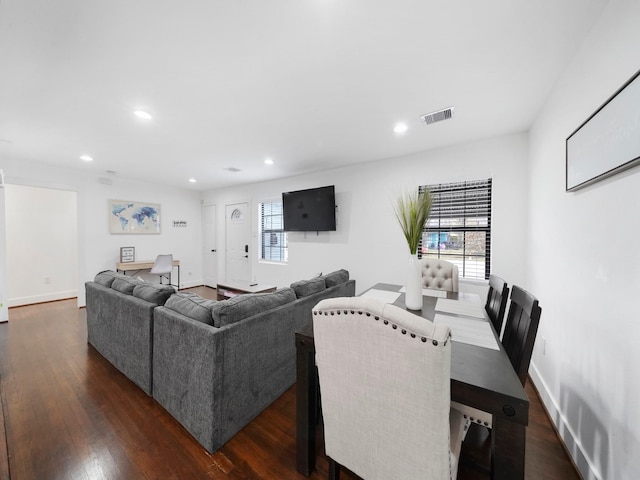 living area with a healthy amount of sunlight, dark wood-type flooring, and recessed lighting