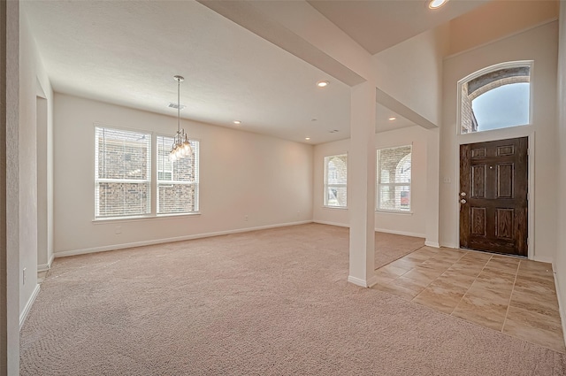 entryway featuring recessed lighting, baseboards, a wealth of natural light, and light colored carpet